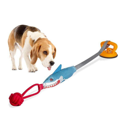 Dog playing with PROKEl Shark Shaped Pet Toy featuring suction cup and chewable design for dental health and mental stimulation.