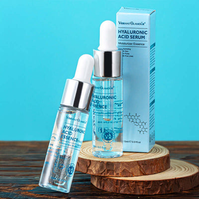 Hyaluronic Acid Face Serum bottle and box on wooden slices with blue background for moisturizing and anti-aging skincare