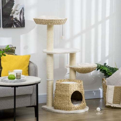 PawHut 47" cat tree with natural woven condo, sisal scratching posts, hanging balls, and plush cushions in modern living room.
