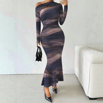 Tie-dyed crossbody shoulder asymmetric fold dress with long sleeves in abstract pattern.